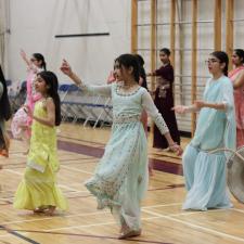 Bhangra Dancers performing in front of elementary students in gym