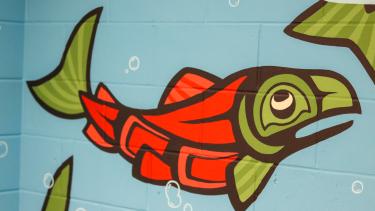 Painted mural of Indigenous art of a salmon