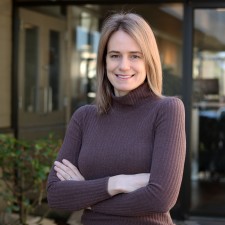 Woman wearing brown turtleneck with blonde hair